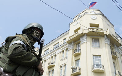 A member of Wagner group stands guard in a street in the city of Rostov-on-Don, on June 24, 2023. (Stringer/AFP)