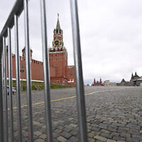 The Spasskaya Tower is seen through metal barriers at Moscow's Red Square on June 24, 2023. (Natalia Kolesnikova/AFP)