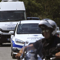 Illustrative -- A motorcyclist police officer escorts and guards a police van, Nicosia, Cyprus, June 24, 2019 (Petros Karadjias/AP)