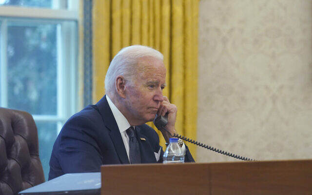 Illustrative: US President Joe Biden takes a phone call in the Oval Office of the White House in Washington on December 9, 2021. (AP Photo/Susan Walsh)