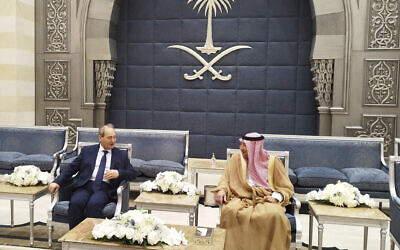 Saudi Deputy Foreign Minister Waleed Al-Khuraiji, right, meets with Syrian Foreign Minister Faisal Mekdad, upon his arrival at King Abdulaziz International Airport, in Jeddah, Saudi Arabia, April 12, 2023. (SANA via AP)