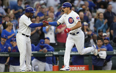 Chicago Cubs' Matt Mervis celebrates his two-run home run off New York Mets starting pitcher Tylor Megill with third base coach Willie Harris during the second inning of a baseball game Tuesday, May 23, 2023, in Chicago. (AP/Charles Rex Arbogast)