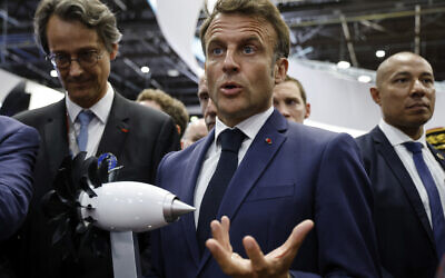 French President Emmanuel Macron gestures by a model of RISE Safran motor at the International Paris Air Show at the Paris Le Bourget airport, Monday, June 19, 2023. (Ludovic Marin, Pool via AP)