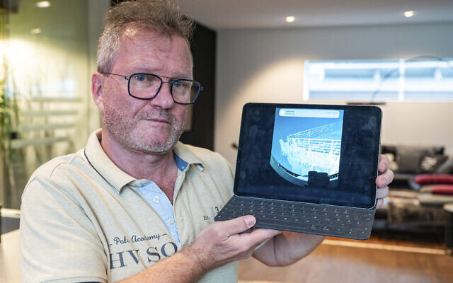 Arthur Loibl, one of the submersible company Oceangate's first customers, holds up a photo of the Titanic, in Straubing, Germany, Wednesday June 21, 2023. Loibl characterized a dive he made to the site two years ago as a 'kamikaze operation.' (Armin Weigel/dpa via AP)