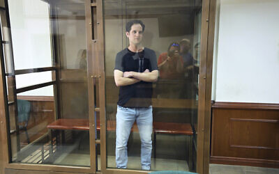 Wall Street Journal reporter Evan Gershkovich stands in a glass cage in a courtroom at the Moscow City Court in Moscow, Russia, June 22, 2023.  (Dmitry Serebryakov/AP)
