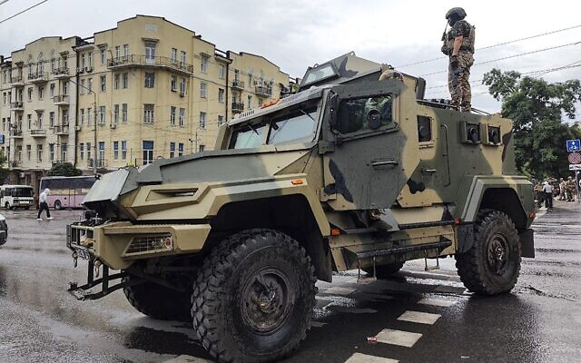A serviceman stands atop of an armored vehicle of the Wagner Group military company, as he guards an area at the HQ of the Southern Military District in a street in Rostov-on-Don, Russia, Saturday, June 24, 2023. (AP)