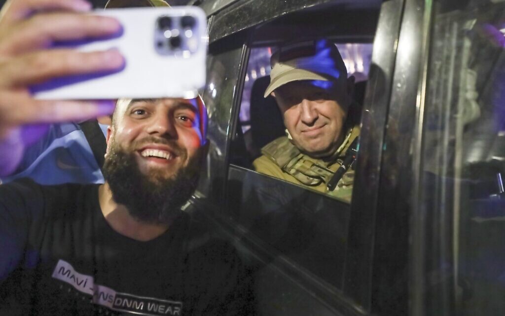 Yevgeny Prigozhin, the owner of the Wagner Group military company, right, sits inside a military vehicle posing for a selfie photo with a local civilian on a street in Rostov-on-Don, Russia, June 24, 2023, prior to leaving an area of the headquarters of the Southern Military District (AP Photo)