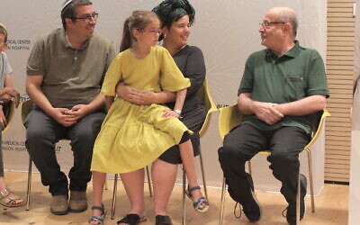 Shalom and Esti Yaniv (left and center) and their daughter Kama meet with Ron Carmeli, who received a donated cornea from Hillel and Yagel Yaniv. Beilinson Hospital, June 18, 2023. (Tamar Cohen)
