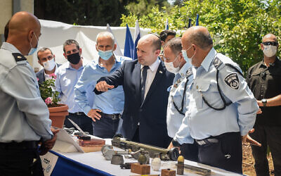 Prime Minister Naftali Bennett, Public Security Minister Omer Barlev and Chief of Police Kobi Shabtai during a ceremony marking the opening of a new police station in the northern Israel city of Kiryat Ata, August 11, 2021. (Roni Ofer/Flash90)
