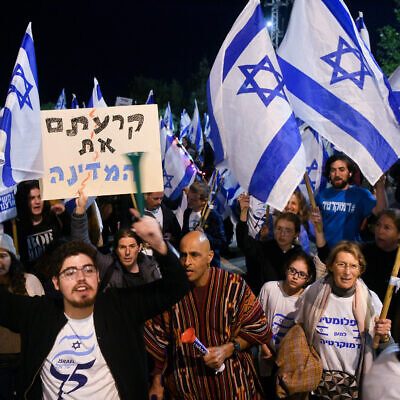 Demonstrators protesting the Israeli government's planned judicial overhaul, outside the official state ceremony celebrating Israel's 75th Independence Day, at Mt Herzl, Jerusalem, April 25, 2023. (Arie Leib Abrams/Flash90)