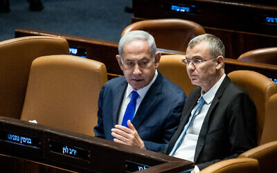 Prime Minister Benjamin Netanyahu (L) with Justice Minister Yariv Levin at the Knesset in Jerusalem, on June 7, 2023. (Oren Ben Hakoon/Flash90)
