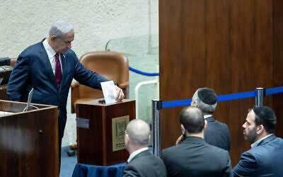 Prime Minister Benjamin Netanyahu votes to nominate lawmakers to sit on the Judicial Selection Committee, June 14, 2023. (Yonatan Sindel/Flash90)
