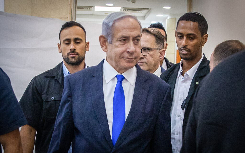 Prime Minister Benjamin Netanyahu arrives at the District Court in Jerusalem to listen to the testimony of businessman Arnon Milchan in his corruption trial on June 25, 2023 (Oren Ben Hakoon/POOL)