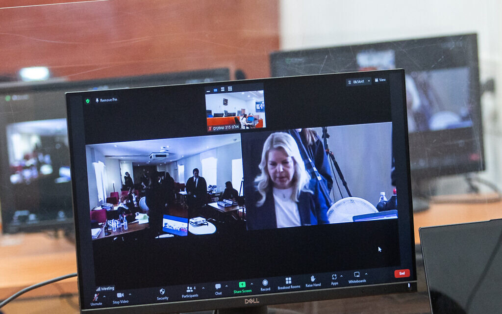 Sara Netanyahu, in the United Kingdom for the testimony of Arnon Milchan in Prime Minister Benjamin Netanyahu's corruption trial, is seen on a screen at the Jerusalem District Court on June 25, 2023 (Oren Ben Hakoon/POOL)