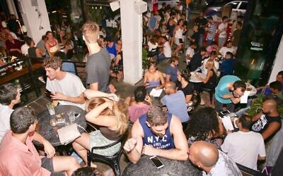 Tourists and locals partying at Tel Aviv's Shpagat bar in Tel Aviv, one of the oldest gay bars in the city (Courtesy)