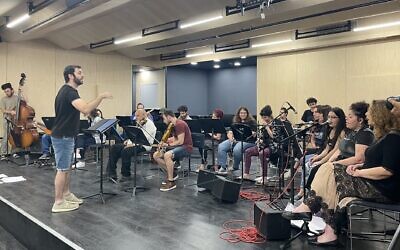 Conductor Ido Marko (far left) during an early June 2023 rehearsal of the Integrative Orchestra, comprising students from the Jerusalem Academy of Music and Dance and Shekel, a Jerusalem program for adults with special needs (Jessica Steinberg/Times of Israel)