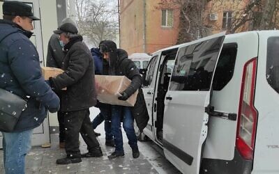 Goods purchased with the help of Kherson region Chief Rabbi Yosef Wolff in Russian-controlled Crimea are unloaded at the synagogue in Russian-occupied Kherson on the Black Sea, March 10, 2022. (Courtesy)