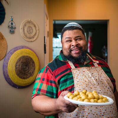 Michael W. Twitty prepares matzah balls with ginger and cayenne pepper for Passover, April 2022. (Johnny Shryock)