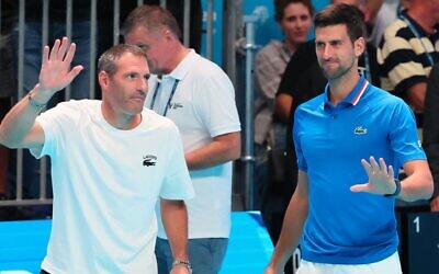 Israeli Jonathan Erlich appears with his friend and former doubles partner Novak Djokovic, right, to explain the cancellation of their scheduled match at the Tel Aviv Watergen Open in Tel Aviv, Sept. 28, 2022. (Jack Guez/AFP via Getty Images via JTA)