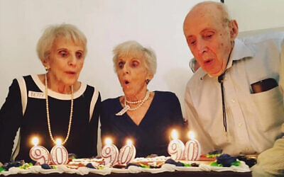 Betty Woolf, left, and her siblings Minna and Joseph celebrate their 90th birthday in 2017. (Courtesy/Jason Paladino via JTA)