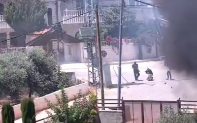 Armed Israeli settlers are seen opening fire in the West Bank town of Turmus Ayya, June 21, 2023. (Screenshot: Twitter)